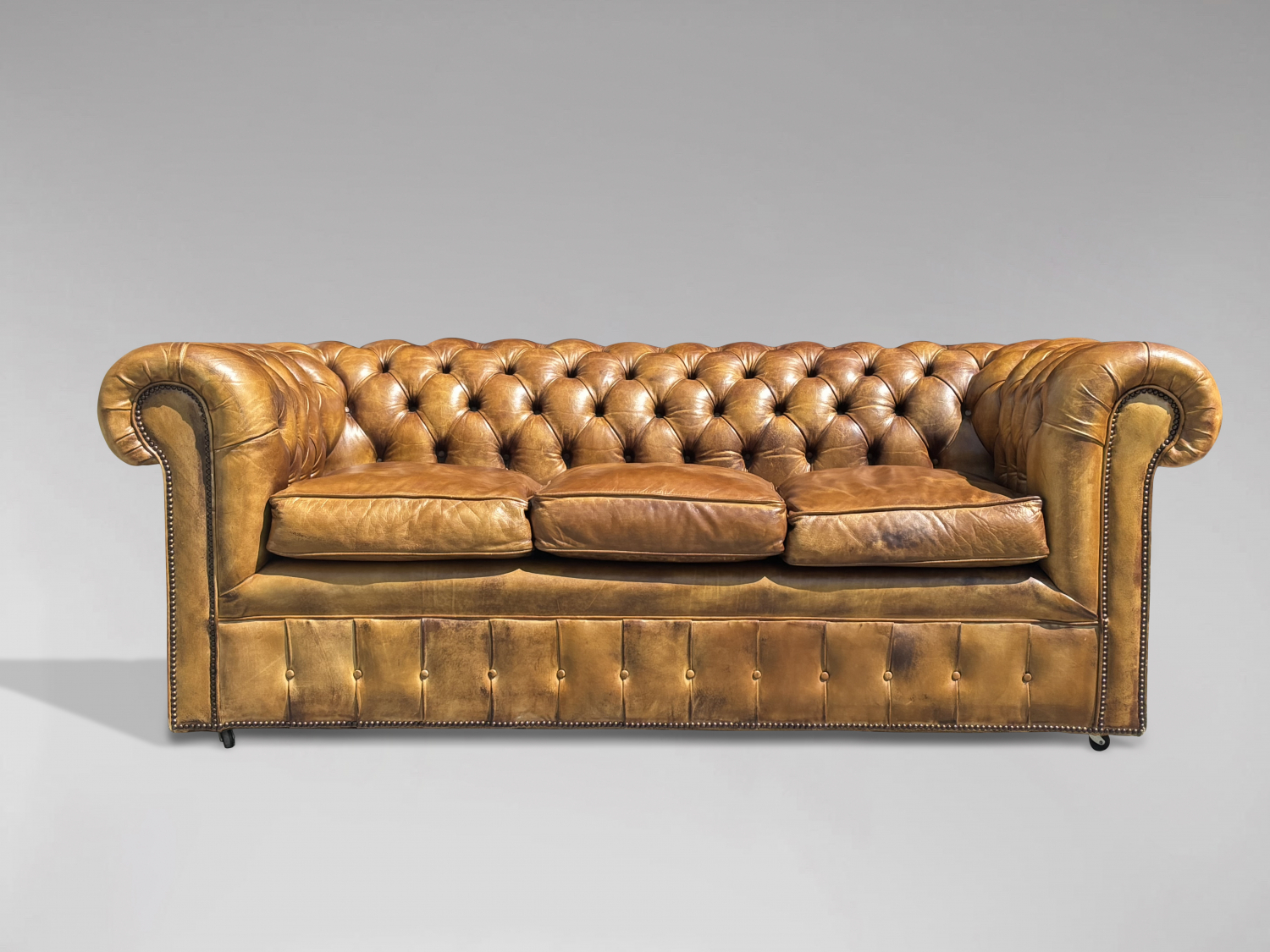 Timeless Elegance: Early 20th-Century Chesterfield Sofa and Victorian Armchairs