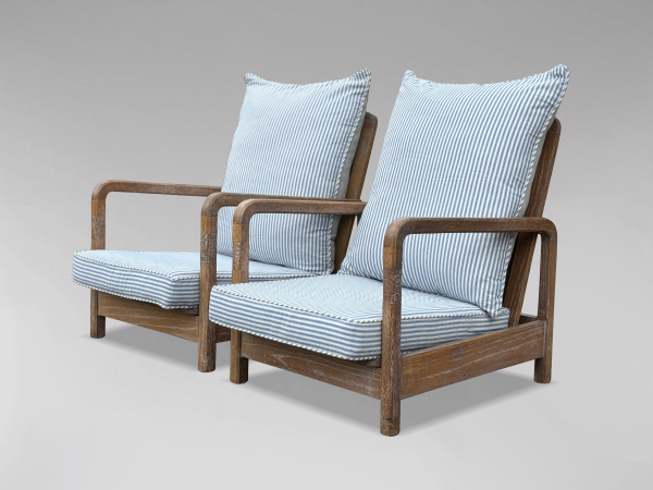 PAIR OF RECLINING ARMCHAIRS IN THE MANNER OF LIBERTY & CO, C1930